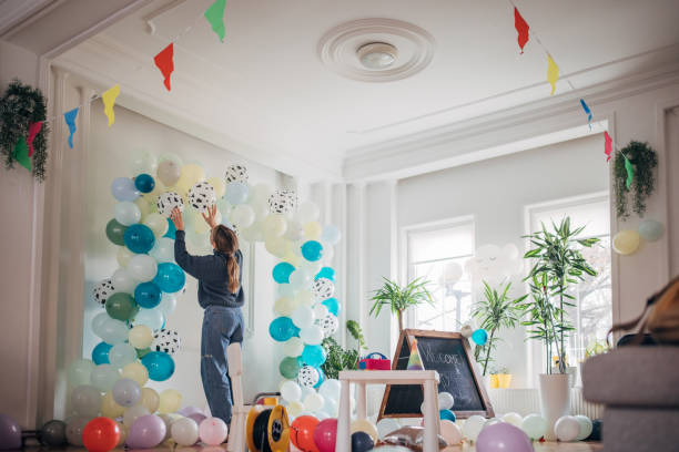 istock Young party planner arranging ballon decoration 1364588041
