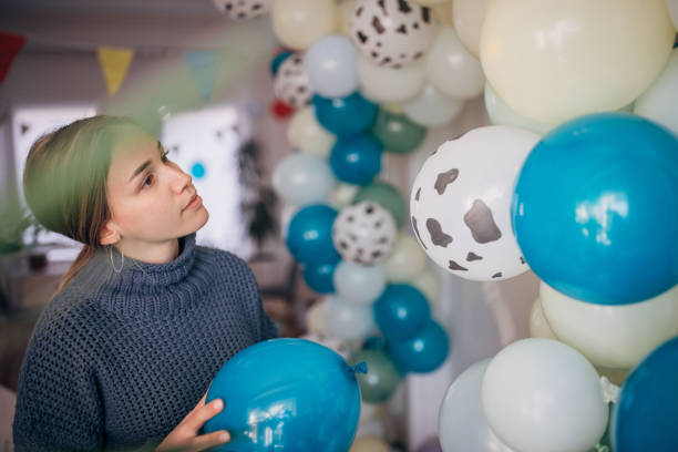 istock Young party planner arranging ballon decoration 1364588847
