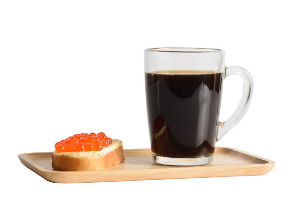 a sandwich with red caviar and a glass of coffee on a wooden tray - plank bread caviar close up imagens e fotografias de stock