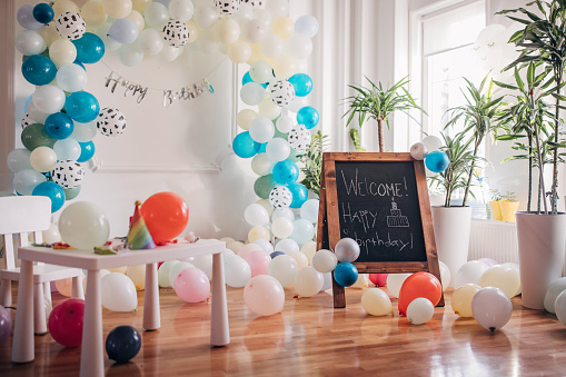 Welcome happy birthday party sign written on the chalkboard