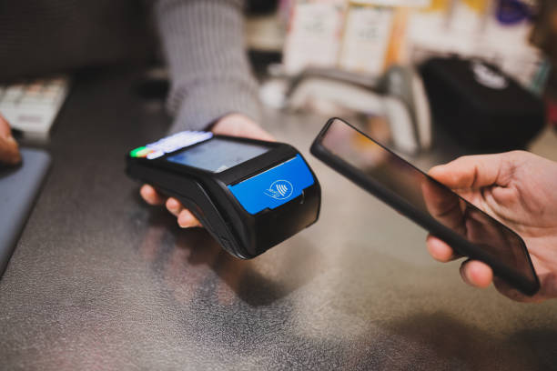 istock Paying with smartphone with NFC technology, , credit card reader, payment terminal. 1364590291