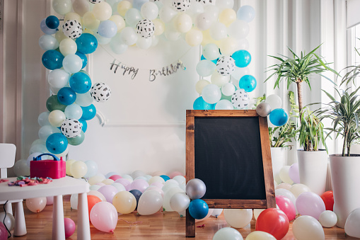 Happy birthday balloon decoration and empty chalkboard sign