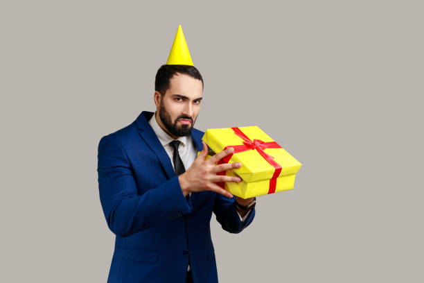 istock Upset man opening gift box and looks inside with disappointed sad expression, unwrapping bad present 1364595639