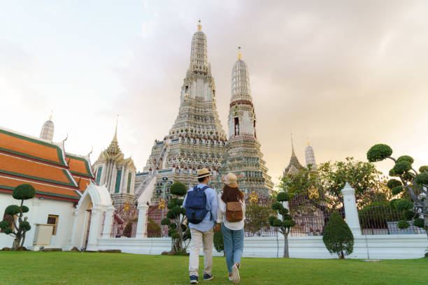Asian couple happy tourists to travel on they holidays and holding in Wat Arun Temple in Bangkok, Thailand Asian couple happy tourists to travel on they holidays and holding in Wat Arun Temple in Bangkok, Thailand wat arun stock pictures, royalty-free photos & images