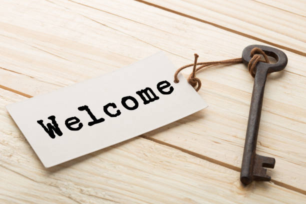 istock Welcome - tag on vintage key, check-in hotel concept 1364596220