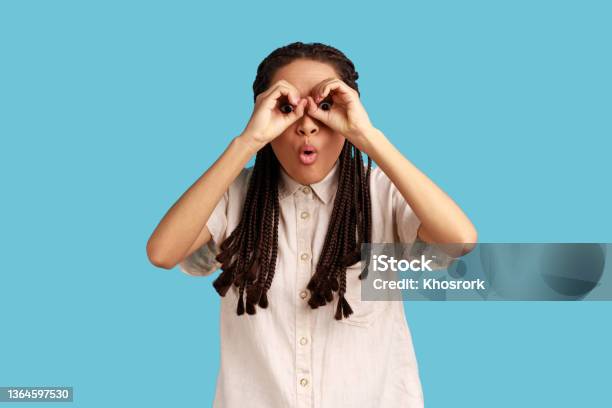 Woman Covering Eyes With Ok Signs Makes Binoculars Foolishes Around And Looks Through Goggles Stock Photo - Download Image Now