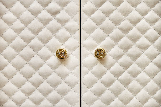 istock Wardrobe covered with beige alcantara and with golden knobs 1364599445