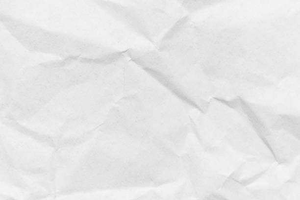istock Grunge wrinkled white color paper textured background 1364600428