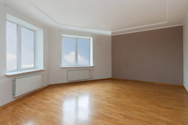 istock Empty unfurnished clean room interior with two sky windows, walls and wooden floor. 3d render 1364600745