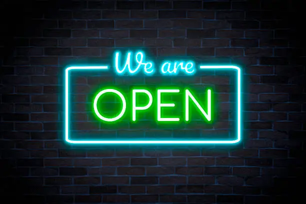 Photo of WE ARE OPEN neon banner, light signboard.