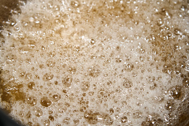 istock bubbling and boiling liquid with bubbles in a brown saucepan 1364601817