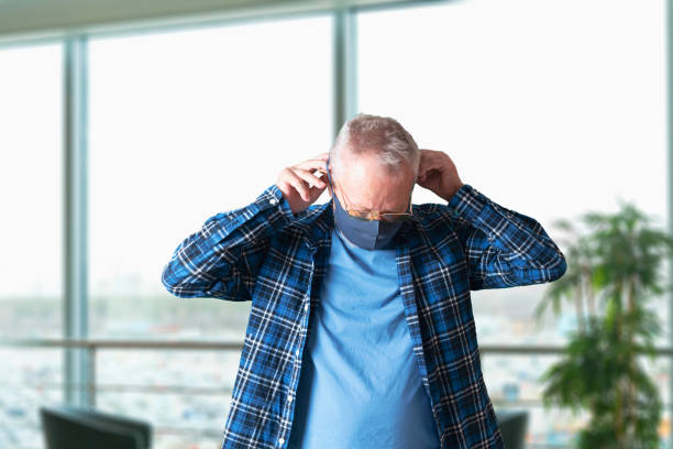 istock old senior man wearing face  mask in public place 1364602165