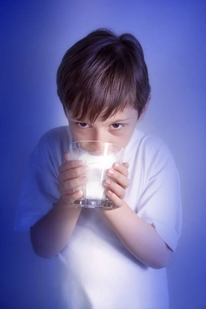A child fills his recyclable glass bottle with fresh milk direct from the farmer to the customer in a vending machine at the farm entrance.