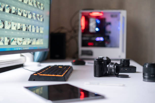 istock photo studio, photographer workplace table with retro style camera and desktop editing computer 1364604185