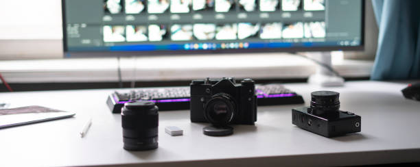 istock photo studio, photographer workplace table with retro style camera and desktop editing computer 1364604188