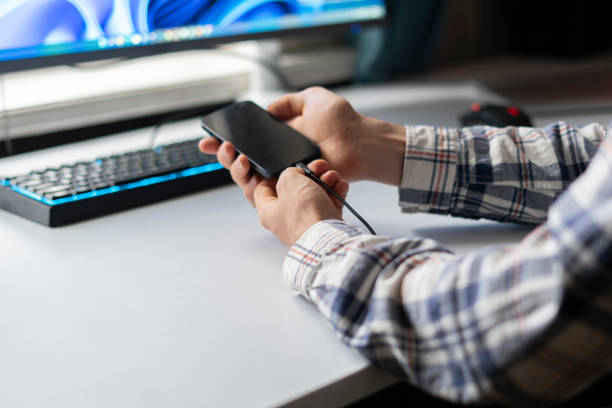 istock person inserting charging cable in smartphone, fast charge new technology 1364604525