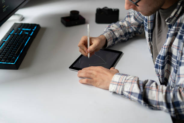 istock male graphic designer working using stiylus and tablet in the studio 1364604587