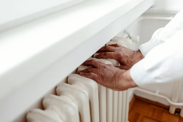 istock Man checking temperature of the radiator. 1364605503