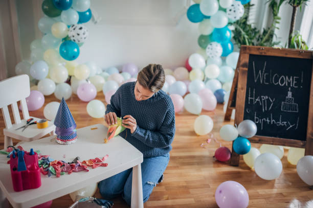 istock Party decorator making birthday party hats 1364605892