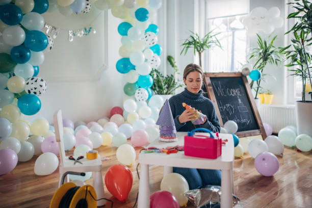 istock Party decorator making birthday party hats 1364605954