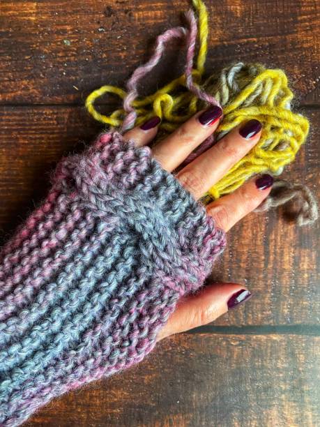 istock Woman’s hand wearing a hand knit fingerless mitten 1364606791