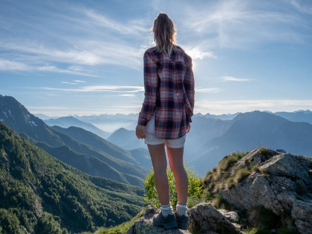 istock Hiker female contemplates view from mountain top 1364607127