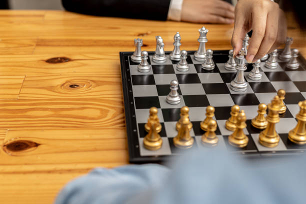 istock Two people playing a game of chess, concept image of two businessmen playing chess compared to a business competition that requires strategic planning and risk-based business management. 1364607768