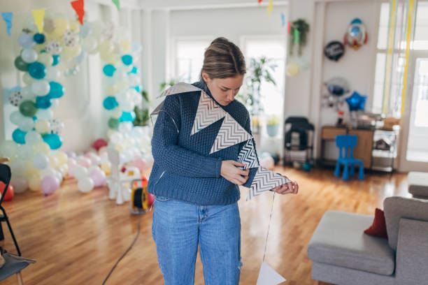 istock Young  decorator hanging party flags and preparing room for celebration 1364607924