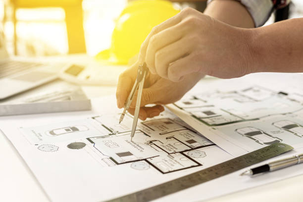 istock Architects, engineers, designers, use compasses to draw on house designs. He is editing the designs that have been created on the program on the computer. Interior design and decoration ideas. 1364609790
