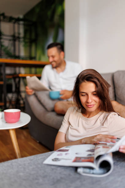 istock Couple reading newspaper and drinking coffee 1364609897