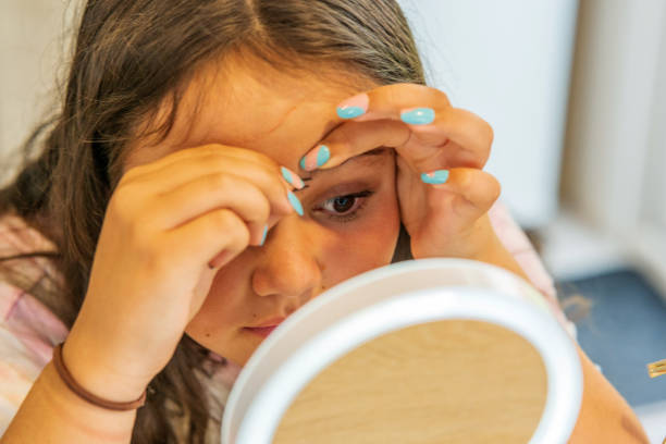 istock Thirteen year old girl close up eyebrows plucked 1364610148