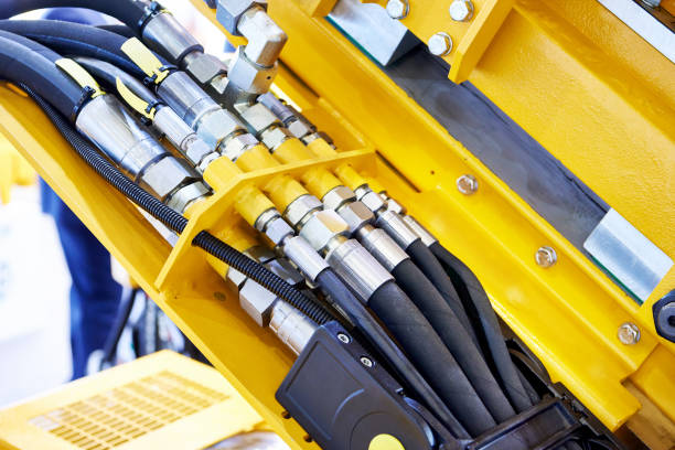Hydraulic hoses and connections Hydraulic hoses and connections on industrial machine hose stock pictures, royalty-free photos & images