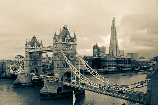 The Tower Bridge northern approach. It is on a grey winters day with traffic on the bridge in London, England, UK.