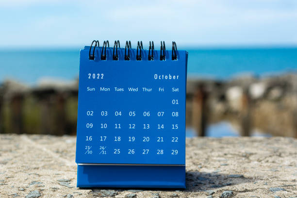 istock Blue October 2022 calendar on blurred background of blue ocean 1364612590