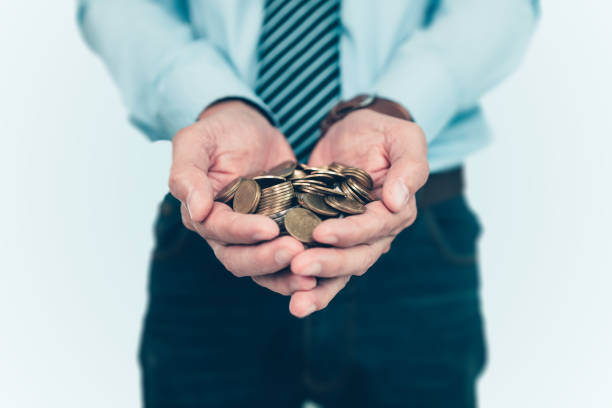 istock coins in businessman hands. Saving money concept. 1364615869