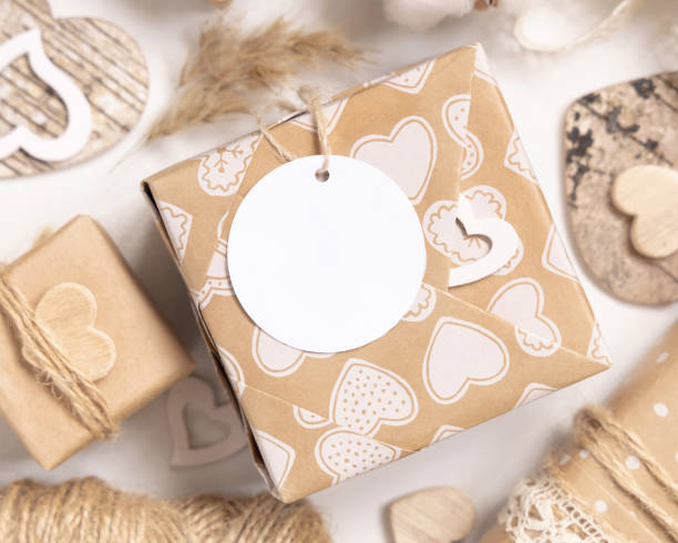 istock Valentines present with round blank gift tag and hearts close up, Rustic label Mockup 1364617332