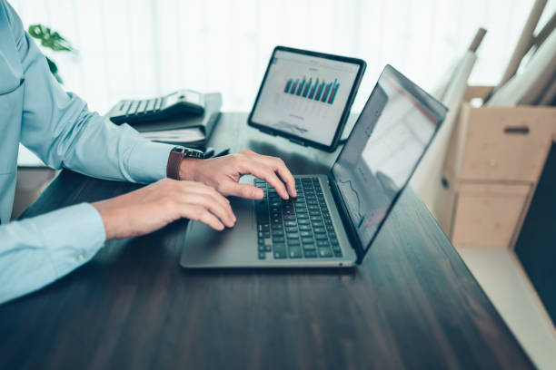 istock Business man working, typing on laptop at office  with document report, graph, financial report. 1364617407