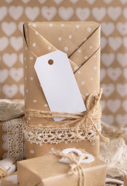 istock Valentines present with blank gift tag and hearts close up, Rustic label Mockup 1364617409
