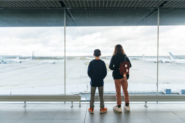 Siblings waiting in airport departure area