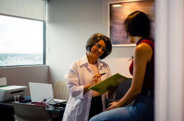 istock Doctor talking to patient in office. 1364618288
