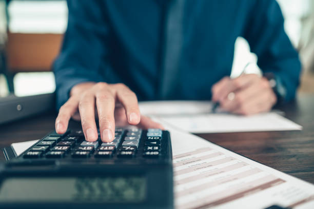 istock Financial businessman working on desk office using a calculator to calculate calculating corporate income tax data And analyzing charts of financial.  finance and accounting concept. 1364618768