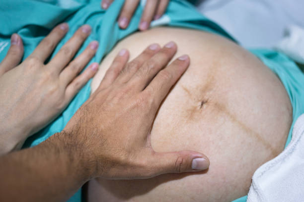 istock A father hand is touching on mother's womb. 1364619061