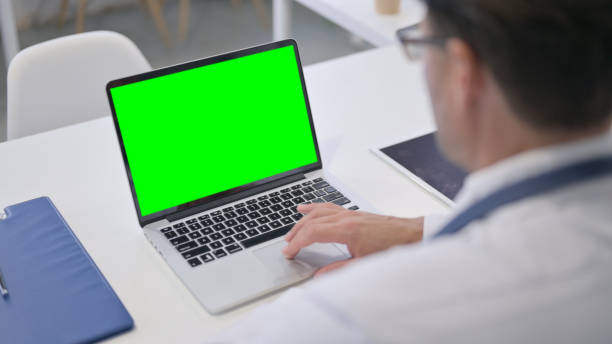 istock Doctor using Laptop with Green Chroma Screen 1364619767