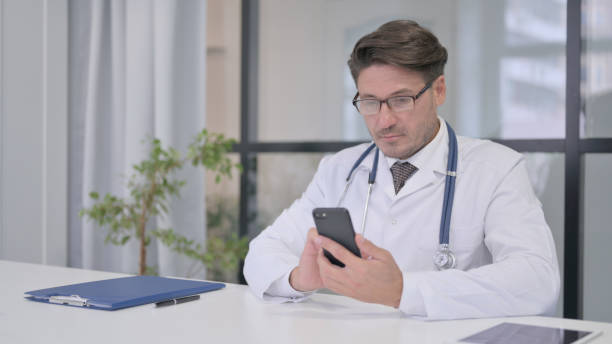 istock Doctor using Smartphone in Clinic 1364619796