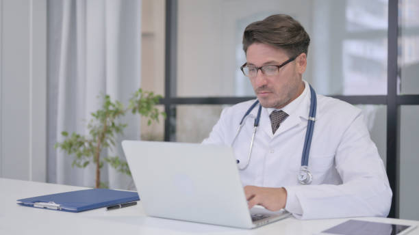 istock Doctor working on Laptop in Clinic 1364619840