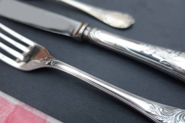 istock Stylish cutlery in silver metal placed on a slate set 1364620042