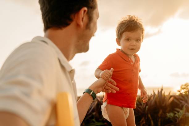 istock Father playing with son at the beach 1364620207