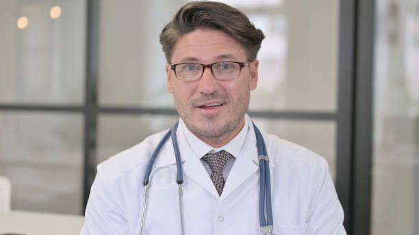 istock Portrait of Doctor Talking on Video Call 1364620621