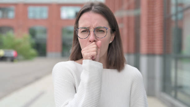 istock Sick Young Woman Coughing Standing Outdoor 1364621645
