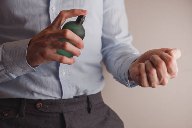 Man in formal wear applying perfume , closeup. Man in formal wear holding perfume bottle, closeup. Space for text cologne photos stock pictures, royalty-free photos & images
